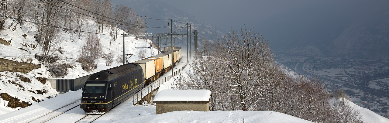 Freight train drives through snow