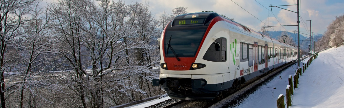 Train drives through winter landscape